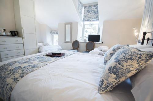 a bedroom with a large bed with two pillows on it at 2 Cambridge Villas B & B in Ambleside