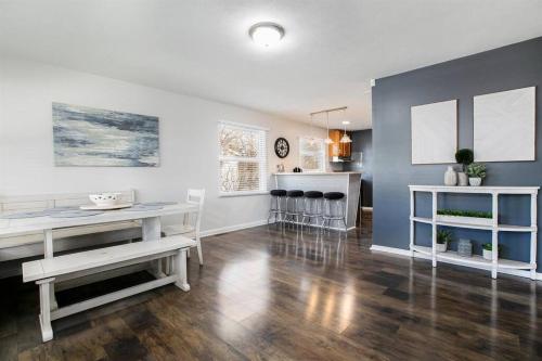 a living room with a table and a kitchen at 4BR Gameday Getaway EV Charger Pet-Friendly 10p in South Bend