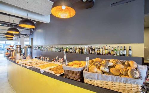 a bakery with a counter with bread and drinks at SB Arenal in El Arenal