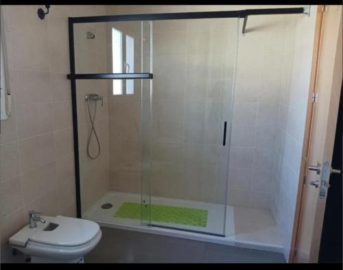 a bathroom with a glass shower with a toilet at Cazorlasalud in Santo Tomé