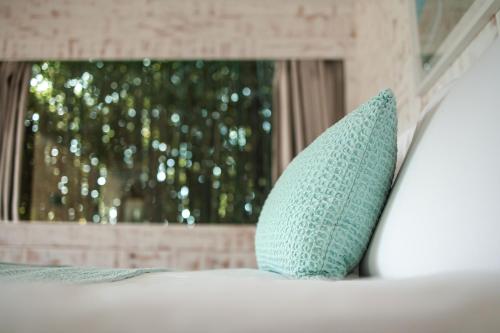 a blue pillow sitting on top of a bed at ES CUCONS RURAL HOTEL in San Antonio