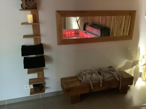 a room with a bed and a mirror on the wall at Le carpe noctem suite de charme avec jacuzzi privé in Sérignan-du-Comtat