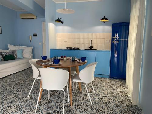 a kitchen and dining room with a table and chairs at Case Borgo vacanze Bouganville in Letojanni