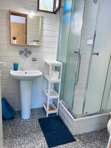 a bathroom with a sink and a shower at Domki Letniskowe Jarek in Rowy