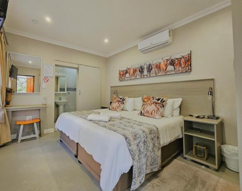 a bedroom with a large bed in a room at Adderley House Guest Accommodation in Robertson
