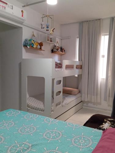 a childs bedroom with a white bunk bed at Cantinho acolhedor da Manu in Salvador