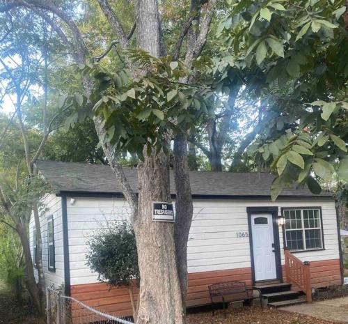 a small house with a tree in front of it at Charming Cozy Cottage Near Southern University! in Baton Rouge