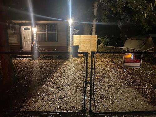 a house with a sign in front of it at night at Charming Cozy Cottage Near Southern University! in Baton Rouge