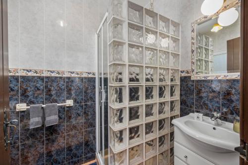 a bathroom with a glass walled shower and a sink at Beautiful Countryside Villa w Private Garden and Pool in Alte