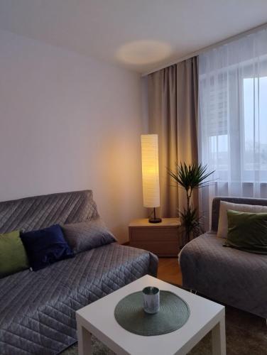 a living room with a couch and a coffee table at GreenApartament in Krakow