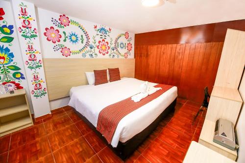 a bedroom with a large white bed in a room at Mayu Boutique Hotel in Cusco
