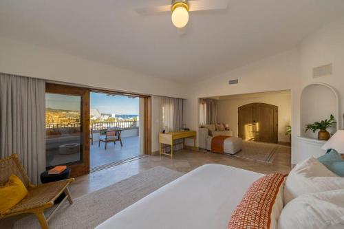 a bedroom with a bed and a room with a view at Casa La Piñata 7BR - Concierge and Maid Included in Cabo San Lucas