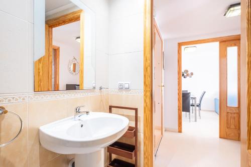 een badkamer met een wastafel en een spiegel bij Tower San Remo 9-E Apartment Levante Beach in Benidorm