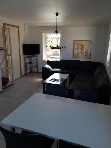 a living room with a couch and a table at Billund countryside Appartement in Give