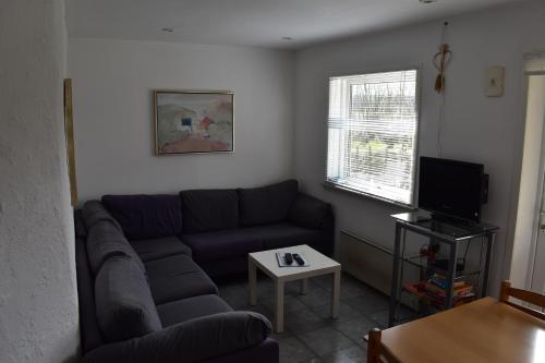 a living room with a couch and a table at Billund countryside Appartement in Give