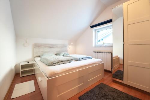 a small bedroom with a bed in a attic at Apartment Premier in Bjelovar