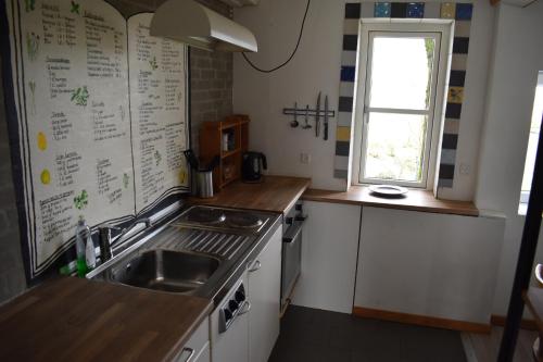 a small kitchen with a sink and a window at Billund countryside Appartement in Give