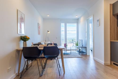 a dining room and living room with a table and chairs at living TIMELESS - Adler Apartments Sasbachwalden in Sasbachwalden