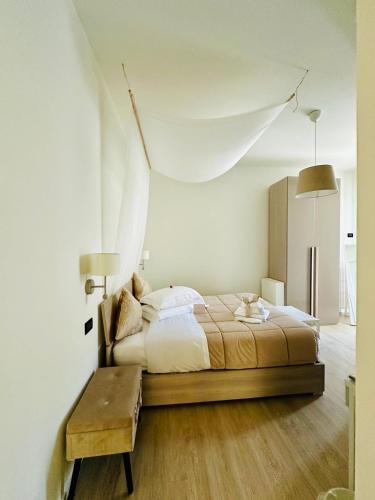 a bedroom with a large bed and a table at Nontiscordardime in Orsogna
