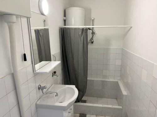 a bathroom with a sink and a toilet and a shower at Gray harmony rooms in Mostar
