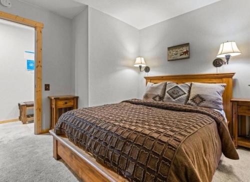 a bedroom with a bed and two lamps and a window at Northstar Ski Trails Condo Walk to Village 3 Year-Round Hot Tubs in Rec. Center in Truckee