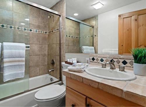 a bathroom with a sink and a toilet and a tub at Northstar Ski Trails Condo Walk to Village 3 Year-Round Hot Tubs in Rec. Center in Truckee