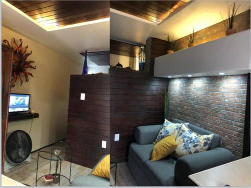 a living room with a couch and a brick wall at Lovely 1 downtown studio in Rosarito