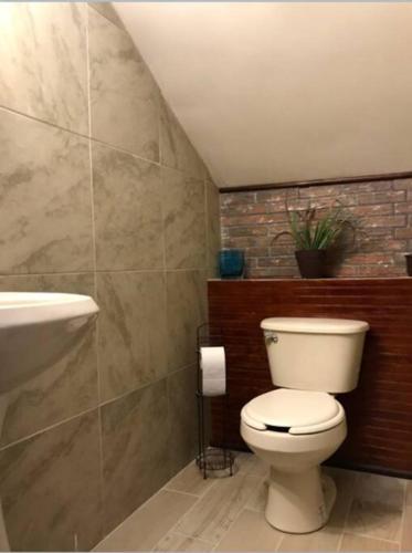 a bathroom with a toilet and a sink at Lovely 1 downtown studio in Rosarito