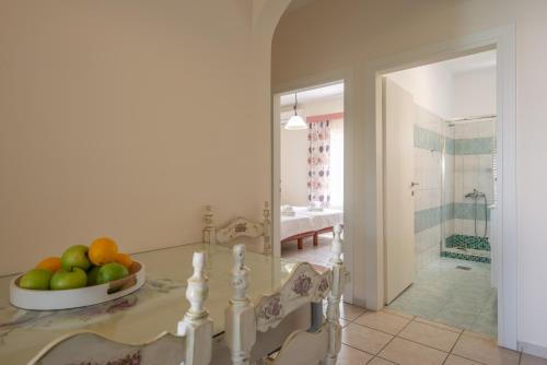 a kitchen with a table and a bowl of fruit at Angela Studios in Sivota