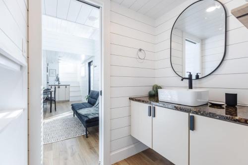 a bathroom with a sink and a mirror at The Narrows Tiny Home in Apple Valley