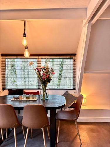 a dining room with a table and chairs and a window at A - (frame) - Like A dream in Durbuy