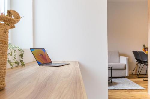 a laptop sitting on a table in a living room at living TIMELESS - Adler Apartments Sasbachwalden in Sasbachwalden