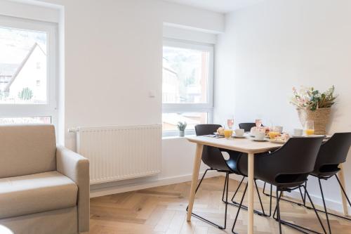 a dining room with a table and chairs at living TIMELESS - Adler Apartments Sasbachwalden in Sasbachwalden