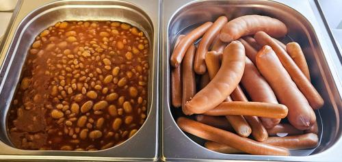 two containers of food with hot dogs and beans at La Familia TYBURA in Uniejow