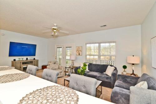 a bedroom with a bed and a living room at Cherry Grove Villa Close to Beach w Pool in Myrtle Beach