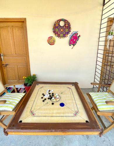 a ping pong table in the middle of a room at Mohalla Rooftop Retreat in Karachi