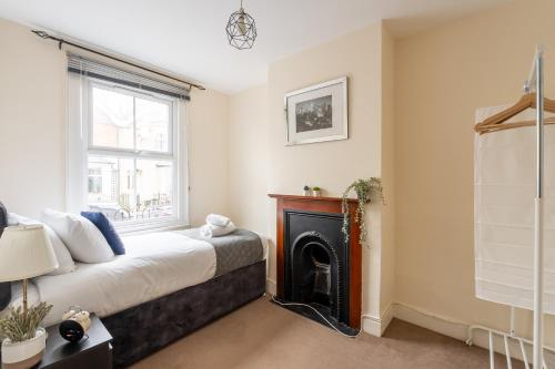 a bedroom with a bed and a fireplace at Edgehill City Centre Haven By Icon Living Properties Short Lets & Serviced Accommodation Reading in Reading