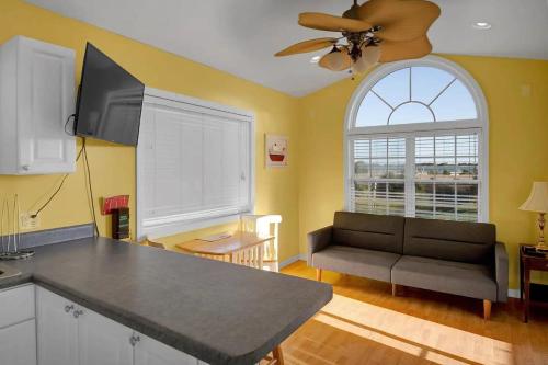 a living room with a couch and a window at Surf City 2BR Model Home with Pool and Boat Ramp Access in Surf City