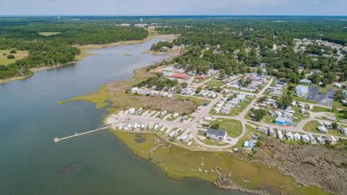 an aerial view of a resort next to a river at Surf City 2BR Model Home with Pool and Boat Ramp Access in Surf City