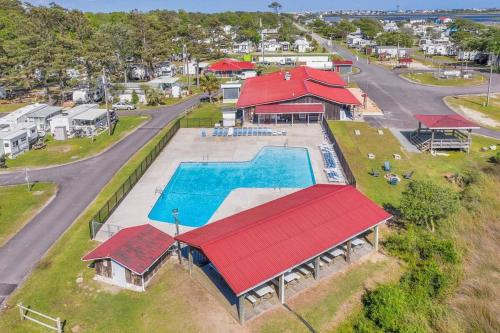 an aerial view of a swimming pool and a house at Surf City 2BR Model Home with Pool and Boat Ramp Access in Surf City