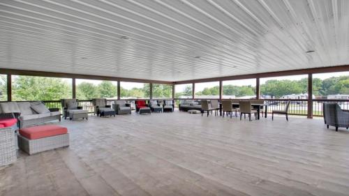 a large room with couches and tables and windows at Rustic Cabin with Views in Bloomington in Bloomington