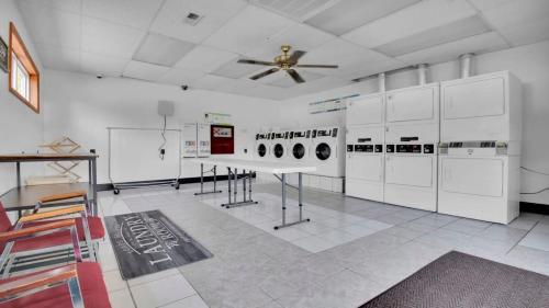 a room with white appliances and a ceiling fan at Rustic Cabin with Pool Access in Bloomington