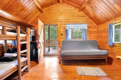 a bedroom with bunk beds in a wooden cabin at Cozy Rustic Cabin with Views in Bloomington