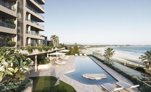 an aerial view of a resort with a swimming pool and the beach at Kirra Point Holiday Apartments in Gold Coast