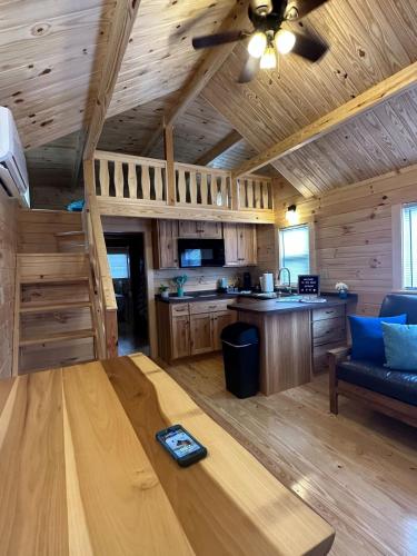 a living room with a table in a log cabin at Get-away Cabin in Surf City w Loft and Parking in Surf City