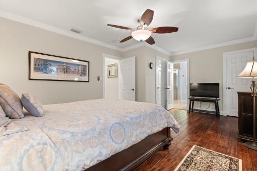 a bedroom with a bed and a ceiling fan at Luxury Mason Villa in Tampa