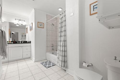 a bathroom with a shower and a toilet and a sink at Luxury Mason Villa in Tampa