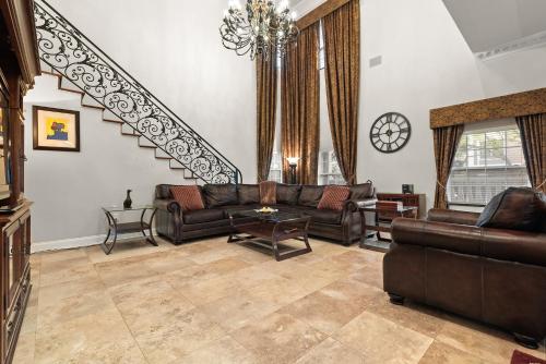 a living room with a couch and a staircase at Luxury Mason Villa in Tampa