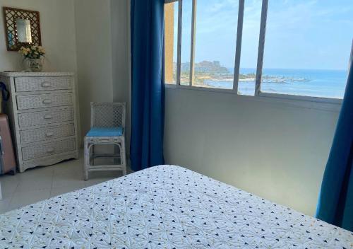 a bedroom with a bed and a view of the ocean at Lagunasol in Porlamar