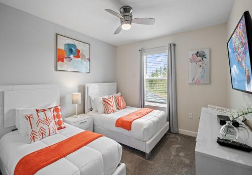 a bedroom with two beds and a couch and a window at Luxury Townhouses 18 Minutes away from Disney! in Kissimmee